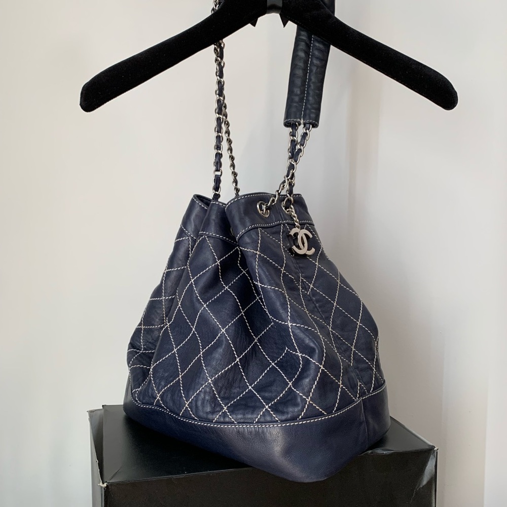 CHANEL Navy Drawstring Lambskin Diamond Stitched Bucket Bag with Medallion
